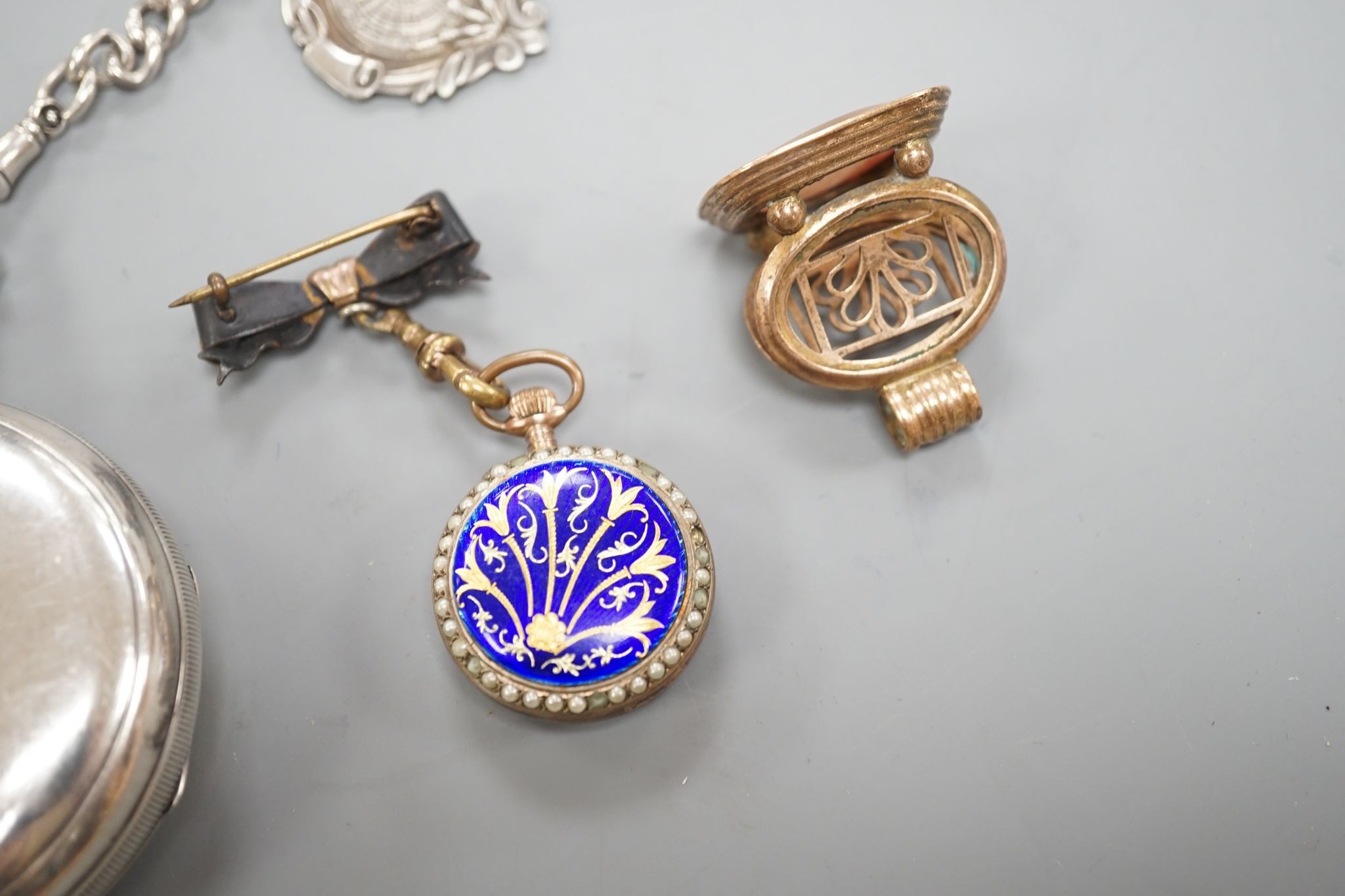 A George V silver open faced lever pocket watch, by A. Yewdall, Leeds, on a silver albert hung with silver medallions, two Swiss white metal and enamel fob watches, gilt fob seal, etc.